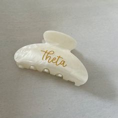 A custom hair clip is a beautiful and practical gift for the sorority girl! Personalized on one side with high-quality vinyl, it's sure to be a well-used gift! ~TO ORDER~ Choose your sorority from the drop-down list.  ~ PRODUCT DETAILS ~ 3-1/4" wide x 2.5" tall with heavy-duty claw design Personalized in high-quality printed vinyl on ONE side of the clip. Add a hair clip with a cute cosmetic bag and we'll bag together to make a cute sorority gift! Hair Clip/Personalization Colors: Theta (Kappa Alpha Theta): ivory/gold letters ~ OTHER INFORMATION ~ Normal turnaround varies by item and is indicated in the shipping information. See shop announcement for variations. If you need an item sooner, please send a message before placing your order.  Happy Thoughts Gifts is a Greek-licensed provider. Personalized Clipboards, Kappa Alpha Theta, Sorority Girl, Duffle Bag Travel, Kappa Delta, Sorority Gifts, Pet Home, Makeup Bags Travel, Gold Letters