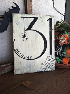 a wooden sign with the number five on it next to some plants and other decorations