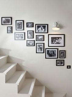 white staircase with black and white pictures on the wall