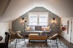 a living room filled with furniture and a window in the wall above it's windows