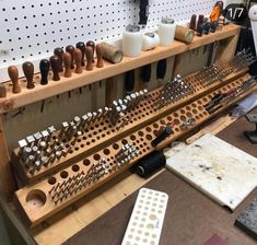 a workbench filled with lots of tools and wooden pegs next to each other