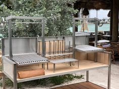 a metal bench sitting on top of a wooden platform