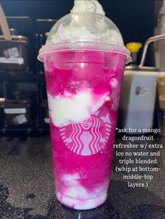 a pink drink with whipped cream on top