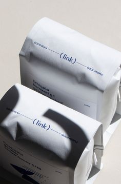 two white envelopes sitting on top of each other with the word think written on them