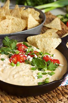 tortilla chips and salsa in a cast iron skillet on a woven place mat