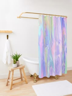 a bath room with a toilet and a bath tub next to a wooden step stool