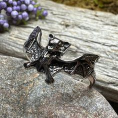 Solid Sterling Silver Bat ring is a perfect accessory to dress up any style. The detail on this piece is amazing - you can see every detail! Wings spread apart with his little head and teeth flashing - the realistic detail is amazing. The bat front piece is 1/2" long and covers the entire front of the finger. The solid sterling silver construction means this ring will last a lifetime! Sizes 5-10 Bat Ring, Bat Jewelry, Vampire Bat, Crystal Design, Bat, Jewelry Design, Dress Up, Sterling Silver, Crystals