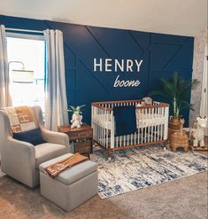 a baby's nursery room with blue walls and white furniture, including a crib