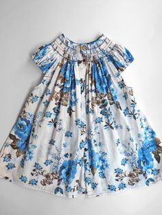 a blue and white dress with flowers on it