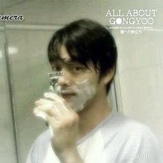 a man shaving his face in front of a mirror with an all about gongyoo logo on it