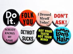 six buttons with different sayings on them