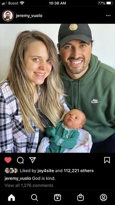 a man and woman holding a baby in front of a wall with the caption's name on it