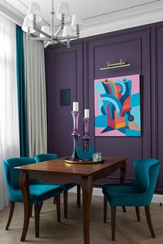 a dining room with purple walls and teal chairs in front of a wooden table