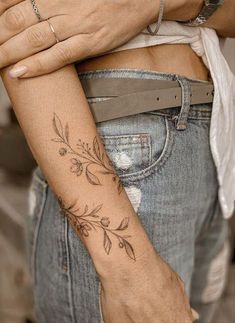 a woman with a flower tattoo on her arm