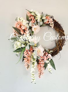 a wreath with pink and white flowers on it