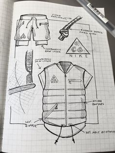 an open notebook with sketches of clothing and accessories on it, including a pencil drawing