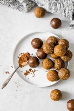 chocolate truffles on a white plate with a spoon