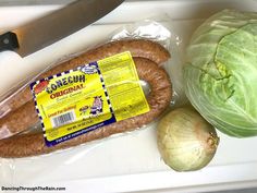 some food is laying out on a cutting board next to a knife and head of cabbage