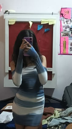 a woman taking a selfie in front of a mirror