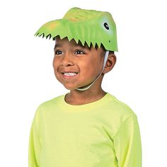 a young boy wearing a green dinosaur hat