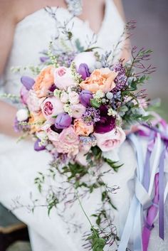 a bridal holding a bouquet of flowers and ribbons