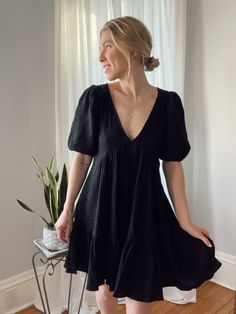 Capture modern allure in this Penny tiered minidress. The V-neck and side seam pockets add practical chic, while voluminous puff sleeves and a back-baring cutout infuse contemporary style. Crafted in gauzy cotton, it exudes summery appeal, making it the perfect blend of fashion and comfort. 100% cotton | hand wash recommended for best care Brooke is 5'4" for reference wearing the small. We recommend your true size! Mini Dresses, Mini Black Dress, Large Black, Puff Sleeves, Contemporary Style, Puff Sleeve, Penny, Black Dress, Hand Wash