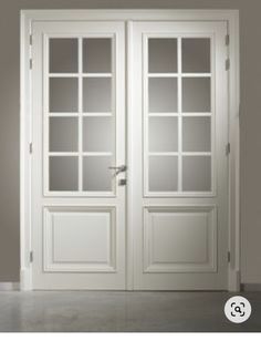 an empty room with two white doors