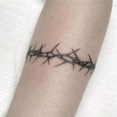 a tattoo with barbed wire on the arm