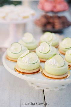 there are many small desserts on the plate and one is white with green icing