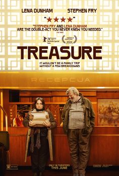 two people standing next to each other in front of a poster for the movie treasure