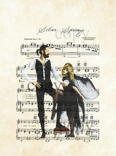 a man and woman dressed in black are standing next to each other on sheet music