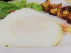 a white plate topped with meat and vegetables