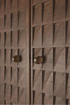 an intricately carved wooden cabinet with brass handles and knobs on the front door