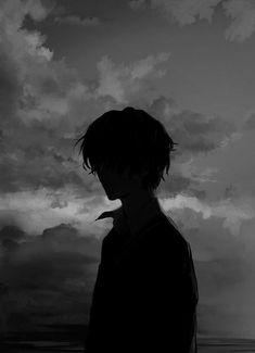 a man standing in front of a cloudy sky