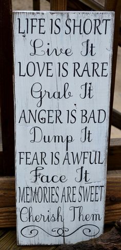 a wooden sign that says life is short, love is rare and anger is bad