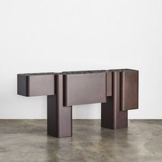 a modern console table with black marble top