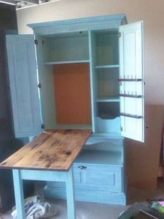 an old fashioned kitchen cabinet is painted blue