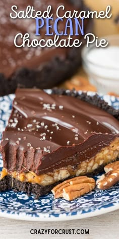 a piece of chocolate caramel ganache pie on a blue and white plate with pecans