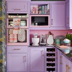 a kitchen with purple cabinets and counter tops