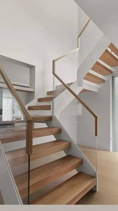 a wooden stair case next to a glass door