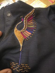 someone is stitching something on the back of a t - shirt with beading