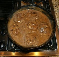 a pot filled with food sitting on top of a stove next to a burner