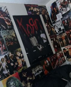 a room with posters on the wall and pictures all over it