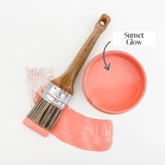 a paintbrush and bowl with the words sunset glow painted on it next to an orange pan