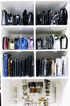 a white shelf filled with lots of purses and handbags