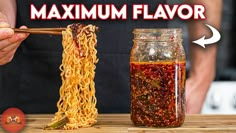 a person is holding chopsticks over noodles in a jar with the words maximum flavor on it