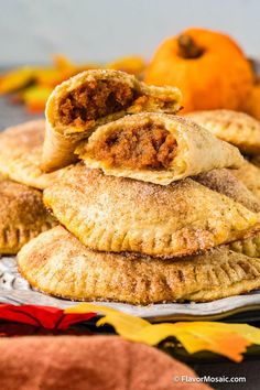 several small pastries stacked on top of each other with pumpkins in the background