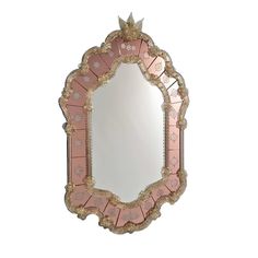 an ornate mirror with pink and gold accents