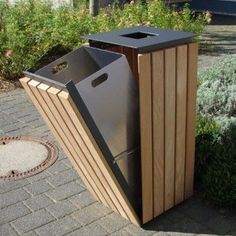 a trash can sitting in the middle of a sidewalk