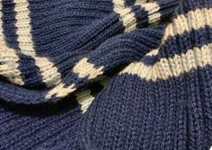 the blue and white sweater is laying on top of each other, with an interesting pattern